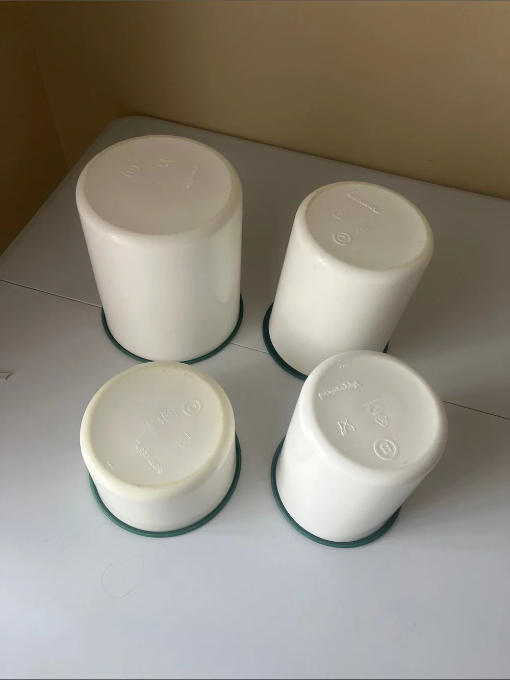 vintage one touch Tupperware Cream Containers with Dark Green Lids set of four
